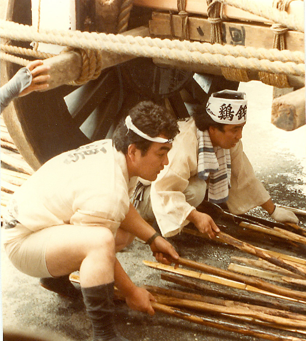 putting bamboo staves under the wheels to turn the cart